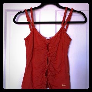 Tank with braided cutout